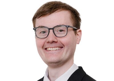A headshot of a man in a suit and tie, taken during a staff session for jnplegal.org by Jo of jodaviesphoto.co.uk.